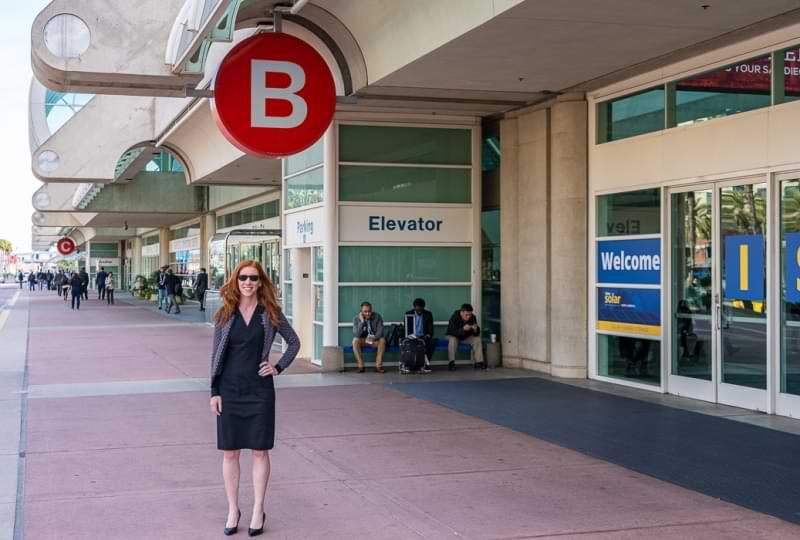 Maren stands in front of a Convention Center entrance